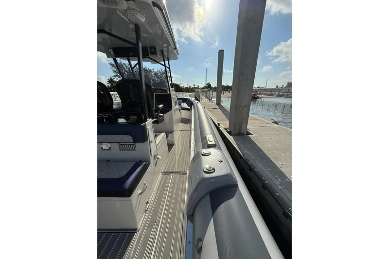 Slide: The Image of 2018 RIB CVL Colt 35 boat docked, showcasing sleek design and seating area. - 26