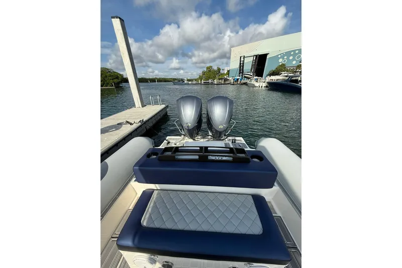 Slide: The Image of 2018 RIB CVL Colt 35 boat with dual engines docked at marina under cloudy sky. - 27