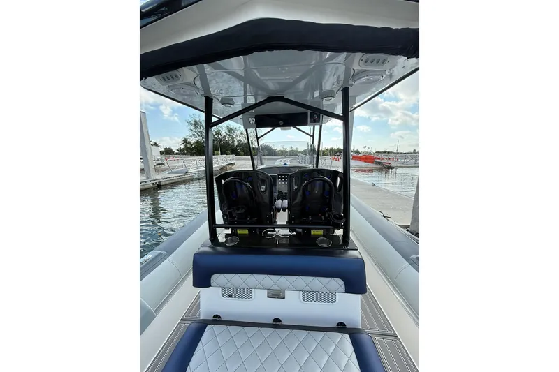 Slide: The Image of 2018 RIB CVL Colt 35 boat interior with seating and control console at dock. - 28