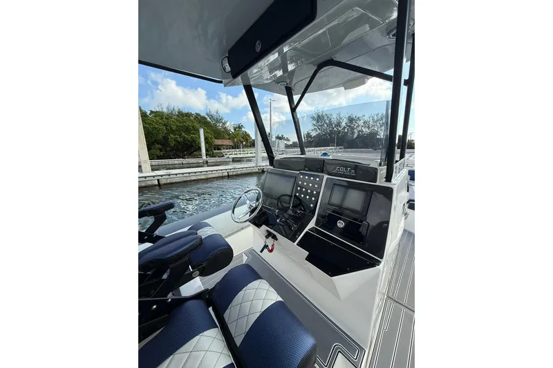 Slide: The Image of 2018 RIB CVL Colt 35 boat cockpit with modern controls and blue seating. - 32