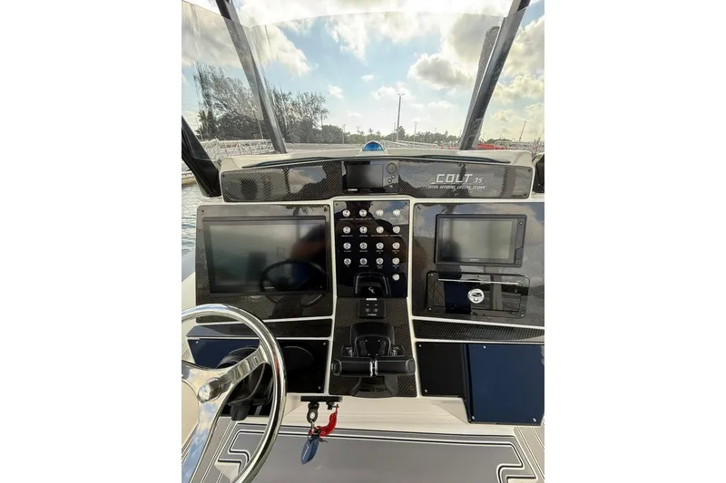 Slide: The Image of 2018 RIB CVL Colt 35 boat dashboard with modern navigation equipment and steering wheel. - 35