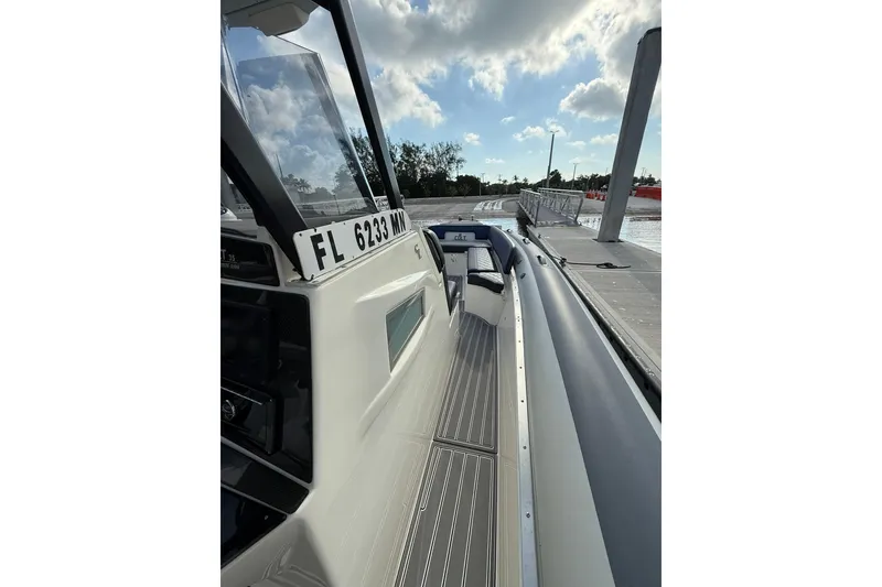 Slide: The Image of 2018 RIB CVL Colt 35 boat docked, showcasing sleek design and registration number. - 37