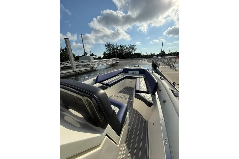 Slide: The Image of 2018 RIB CVL Colt 35 boat docked, featuring sleek seating and modern design under a partly cloudy sky. - 38