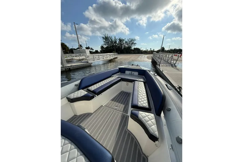 Slide: The Image of 2018 RIB CVL Colt 35 boat interior with blue and white seating, docked by a pier. - 39