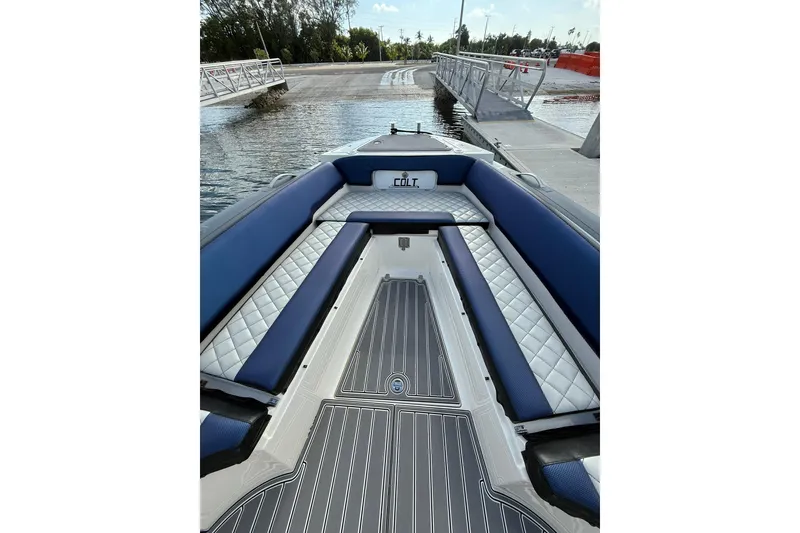 Slide: The Image of 2018 RIB CVL Colt 35 boat interior with blue and white seating at dock. - 40