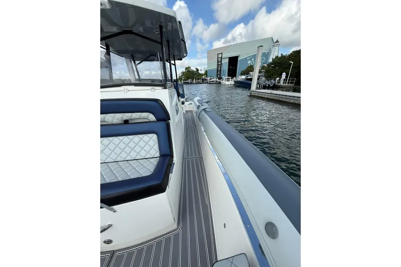 Slide: The Image of RIB CVL Colt 35 boat, 2018 model, docked by a marina with clear skies. - 46