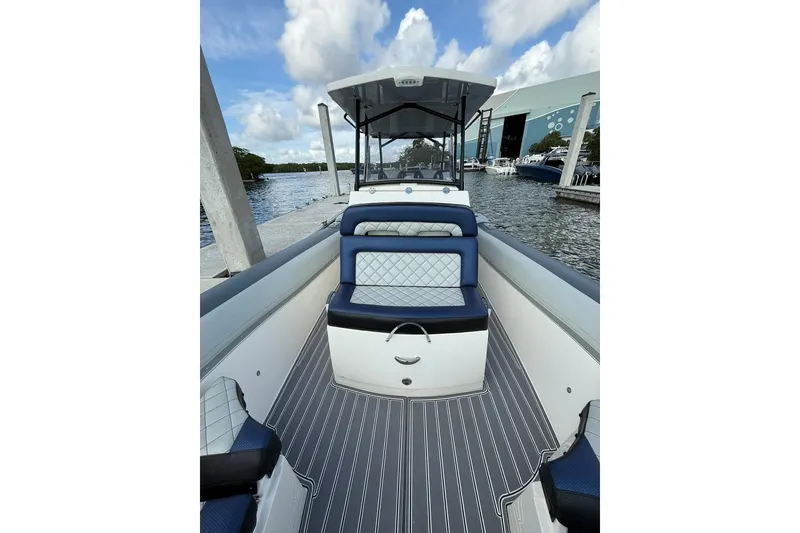 Slide: The Image of 2018 RIB CVL Colt 35 boat interior with blue seating, docked by the water. - 47