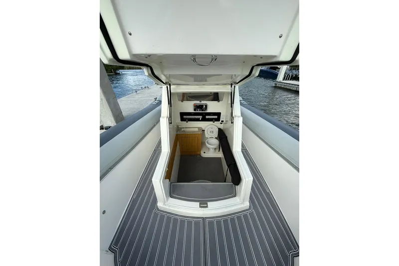 Slide: The Image of RIB CVL Colt 35 boat interior with toilet, docked by the water, 2018 model. - 50