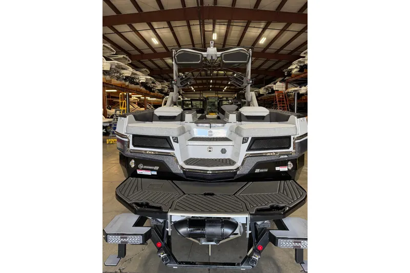 Slide: The Image of 2026 MasterCraft XStar 25 boat in warehouse, rear view showcasing design and features. - 5