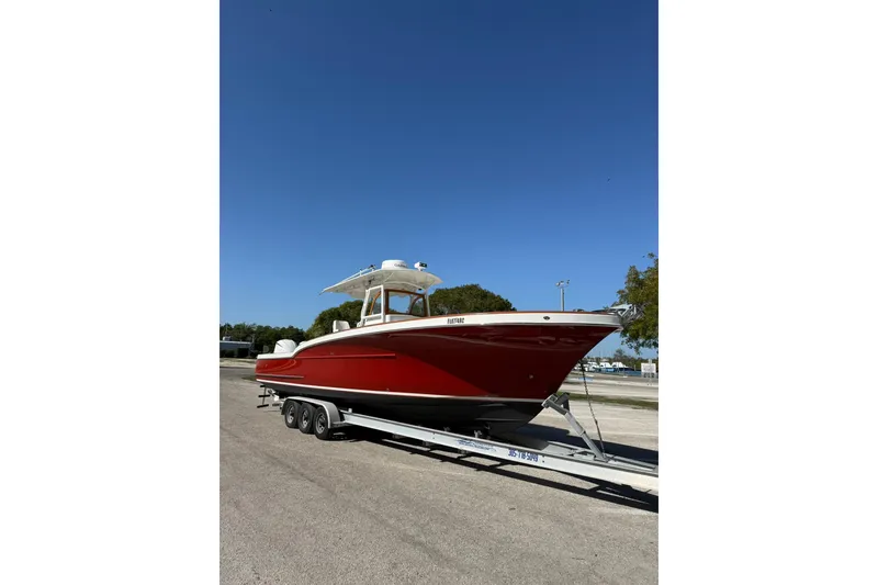 Slide: The Image of 2006 Buddy Davis 34 Center Console boat on trailer under clear blue sky. - 10