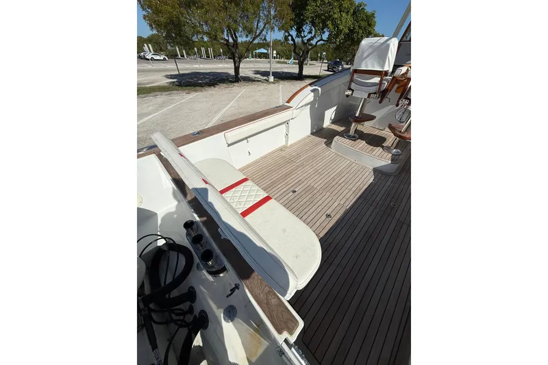 Slide: The Image of 2006 Buddy Davis 34 Center Console boat interior with wooden deck and seating. - 17