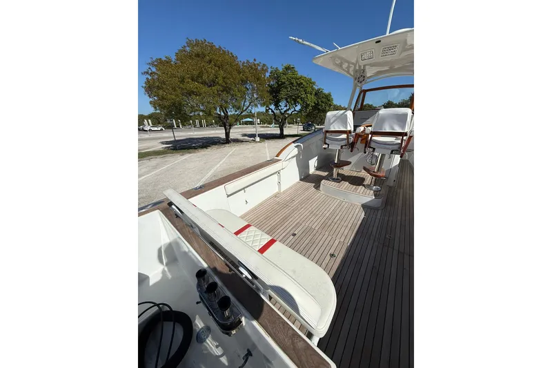 Slide: The Image of 2006 Buddy Davis 34 Center Console boat interior with seating and wooden deck. - 18