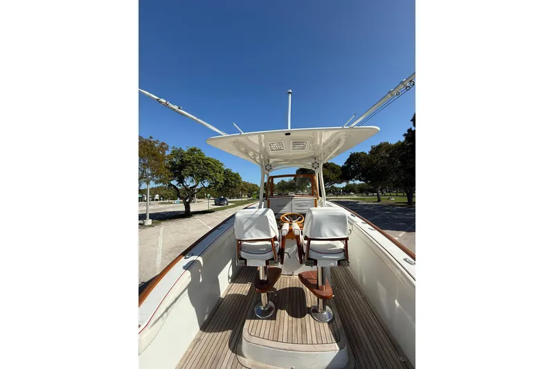 Slide: The Image of 2006 Buddy Davis 34 Center Console boat with dual seats and clear blue sky. - 20