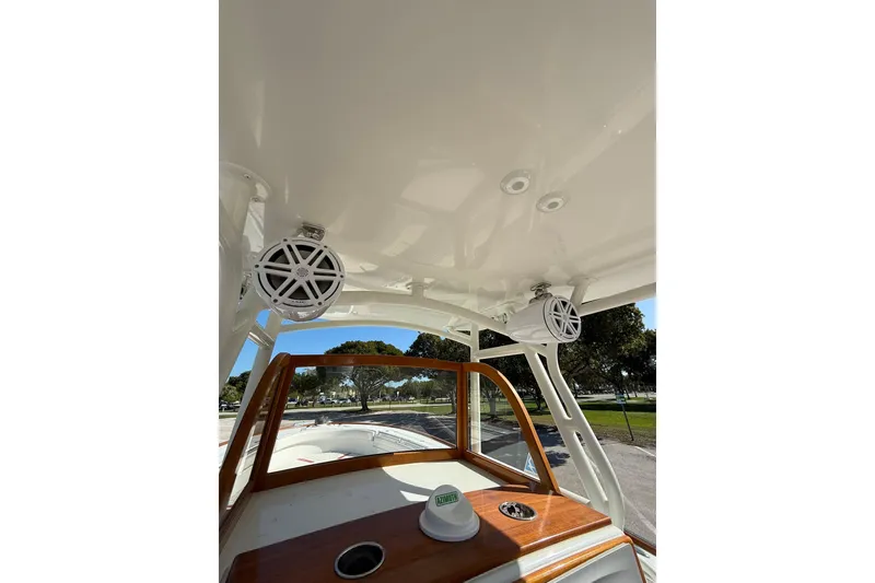 Slide: The Image of 2006 Buddy Davis 34 Center Console boat interior with speakers and wooden dashboard. - 28