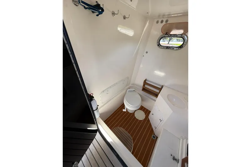 Slide: The Image of Interior of 2006 Buddy Davis 34 Center Console boat with toilet and porthole. - 31