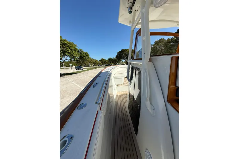 Slide: The Image of 2006 Buddy Davis 34 Center Console boat deck with clear blue sky background. - 35