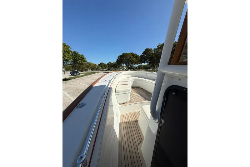 Slide: The Image of 2006 Buddy Davis 34 Center Console boat with spacious deck and seating under clear blue sky. - 36