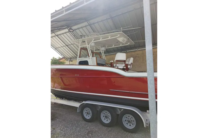 Slide: The Image of 2006 Buddy Davis 34 Center Console boat on trailer, parked in sunny lot. - 4