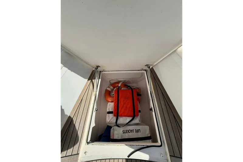 Slide: The Image of Storage compartment on 2006 Buddy Davis 34 Center Console with life jackets and safety gear. - 41