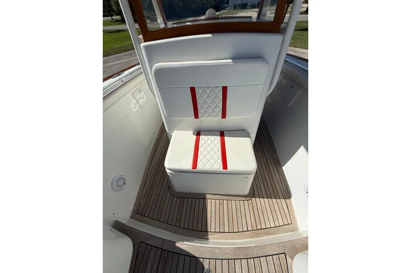 Slide: The Image of 2006 Buddy Davis 34 Center Console boat seat with red accents and wooden flooring. - 42