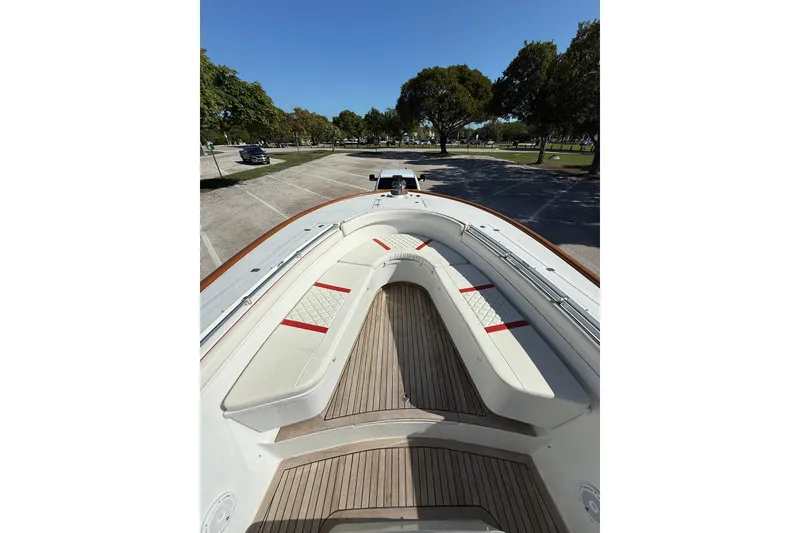 Slide: The Image of 2006 Buddy Davis 34 Center Console boat with cushioned seating and wooden deck. - 44