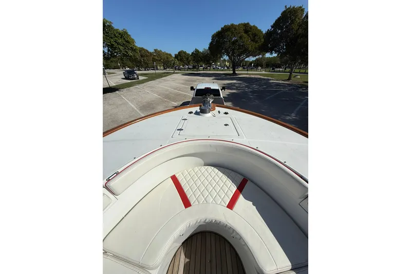 Slide: The Image of 2006 Buddy Davis 34 Center Console boat parked, featuring white and red cushioned seating. - 45