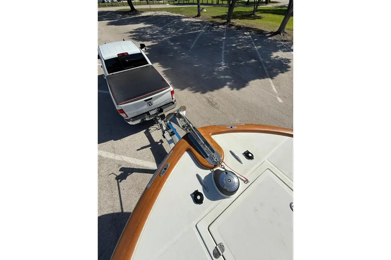 Slide: The Image of A 2006 Buddy Davis 34 Center Console boat hitched to a white pickup truck. - 46