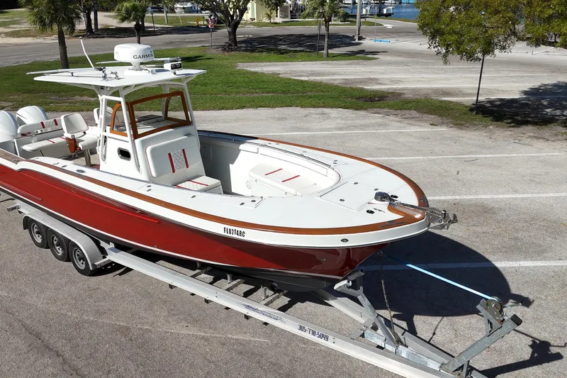 Slide: The Image of 2006 Buddy Davis 34 Center Console boat on trailer, parked outdoors. - 5