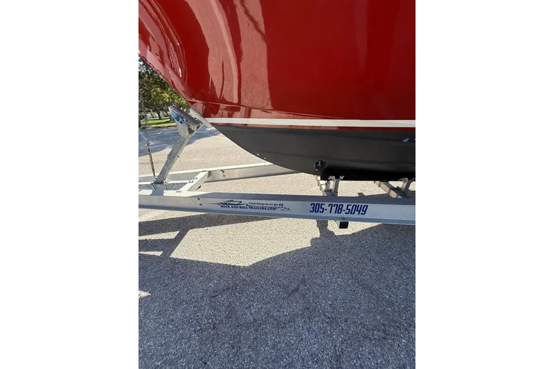 Slide: The Image of Red 2006 Buddy Davis 34 Center Console boat on trailer, parked on pavement. - 53