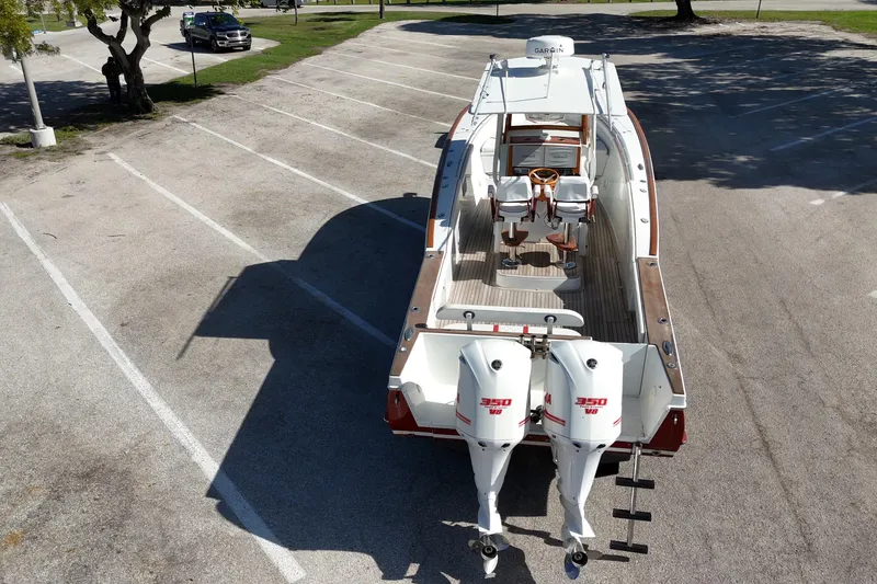 Slide: The Image of 2006 Buddy Davis 34 Center Console boat with twin 350 V8 engines in a parking lot. - 7