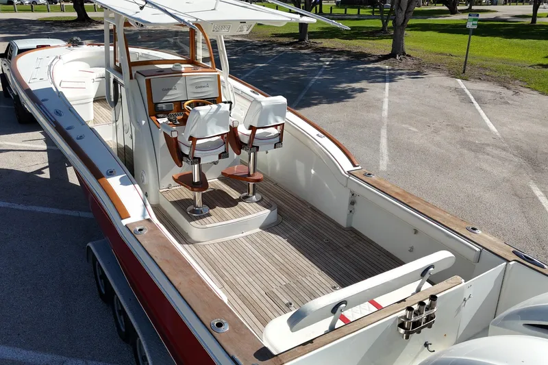 Slide: The Image of 2006 Buddy Davis 34 Center Console boat with dual helm seats and wood accents. - 8