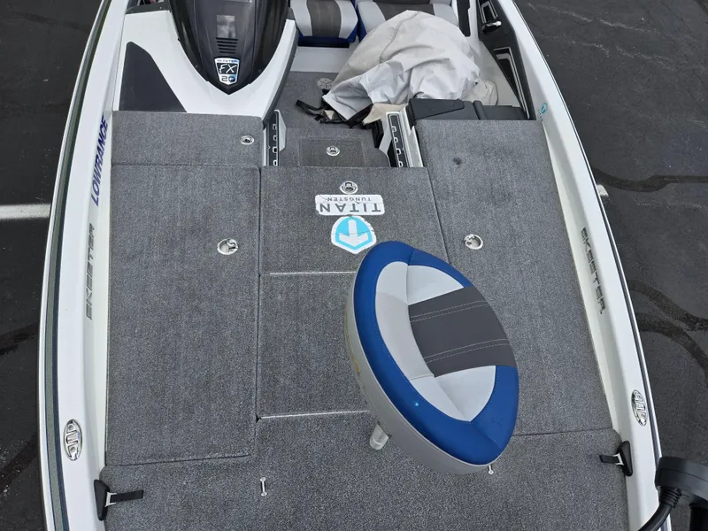 Slide: The Image of 2015 Skeeter FX 20 boat deck with blue and gray seat, featuring Titan logo. - 19