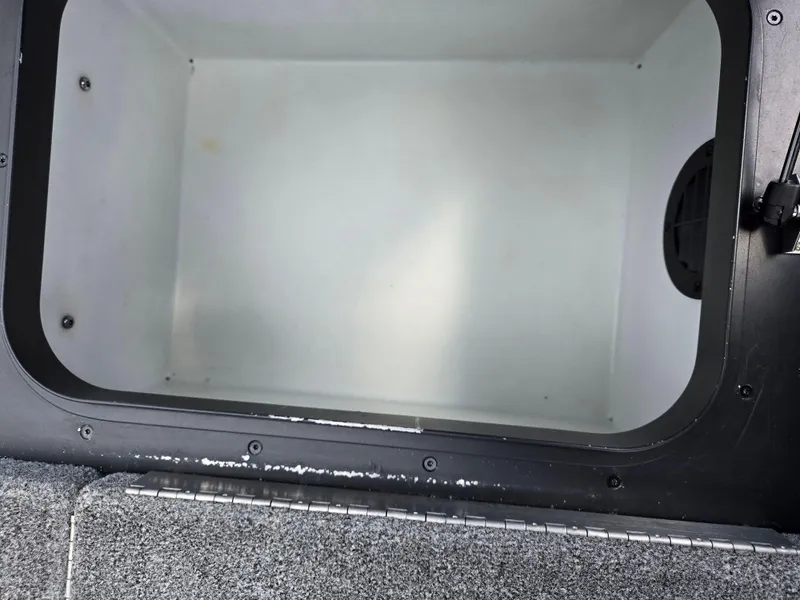 Slide: The Image of 2015 Skeeter FX 20 boat storage compartment, open and empty, with a clean interior. - 24