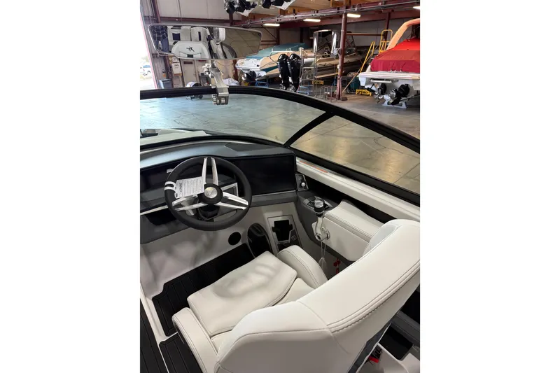 Slide: The Image of Interior of a 2026 MasterCraft XT23 boat, featuring a sleek steering wheel and modern dashboard. - 5