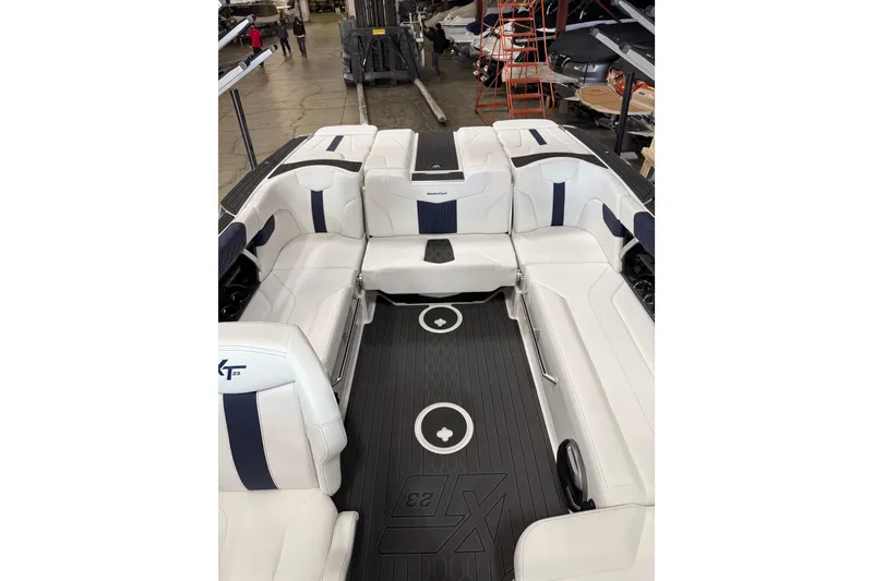 Slide: The Image of 2026 MasterCraft XT23 boat interior with white seating and sleek design. - 7