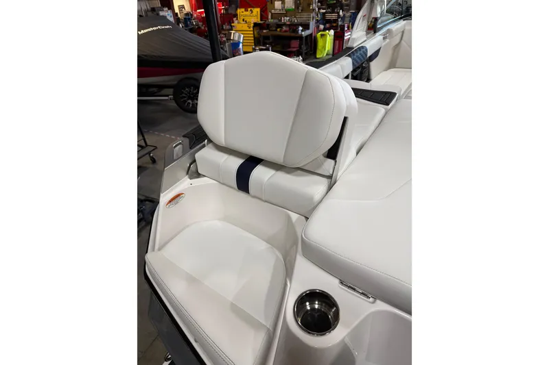 Slide: The Image of 2026 MasterCraft XT23 boat interior with white seating and cup holder. - 9