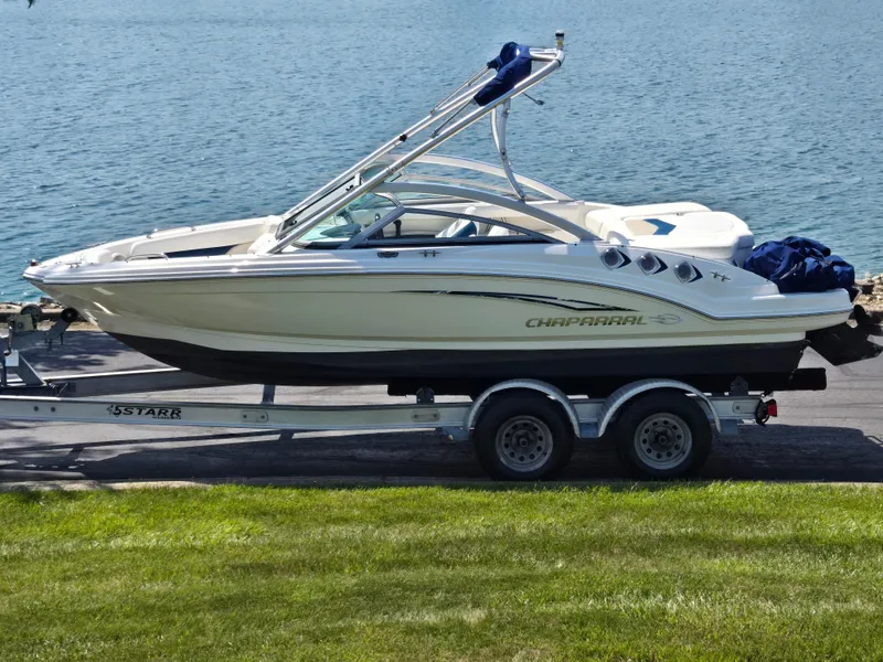 The Image of 2011 Chaparral 196 SSi boat on trailer by a lake. - 0