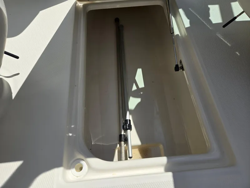 Slide: The Image of Storage compartment in 2011 Chaparral 196 SSi boat, featuring a clean, spacious interior. - 12