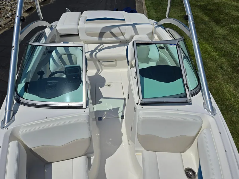 Slide: The Image of 2011 Chaparral 196 SSi boat interior with white seating and open windshield. - 21