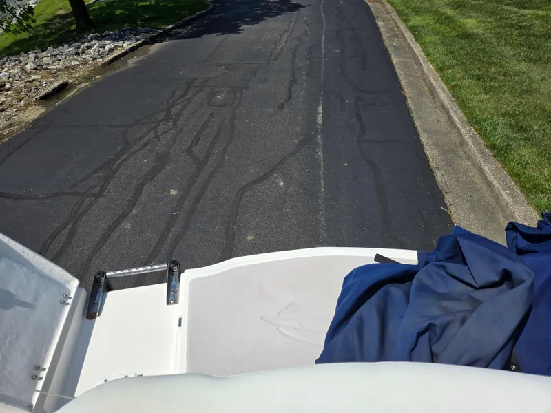 Slide: The Image of 2011 Chaparral 196 SSi boat on a paved road, blue cover partially visible. - 26