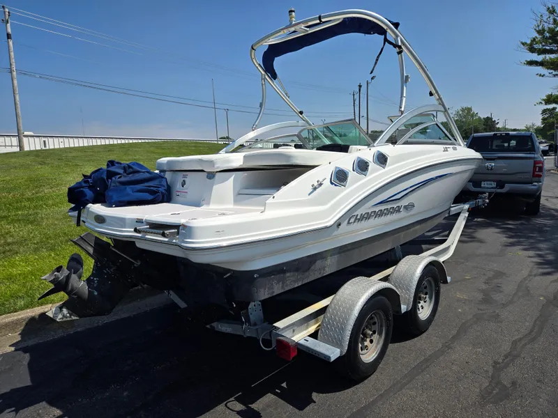 Slide: The Image of 2011 Chaparral 196 SSi boat on trailer, parked outdoors, with blue canopy. - 3