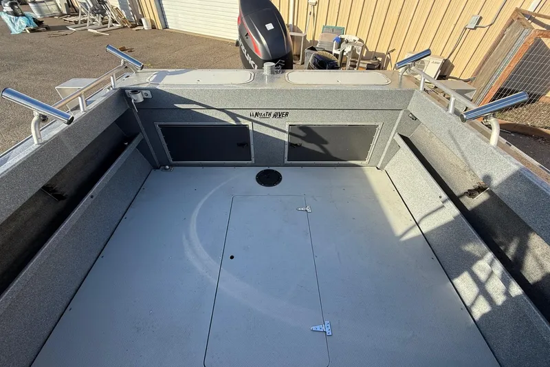 Slide: The Image of 2016 North River Seahawk boat interior with rod holders and storage compartments. - 10