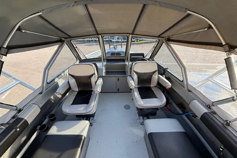 Slide: The Image of 2016 North River Seahawk boat interior with seating and steering console. - 13