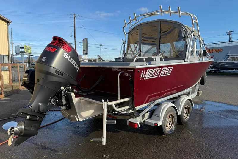 Slide: The Image of 2016 North River Seahawk boat with Suzuki 150 outboard motor on trailer. - 2