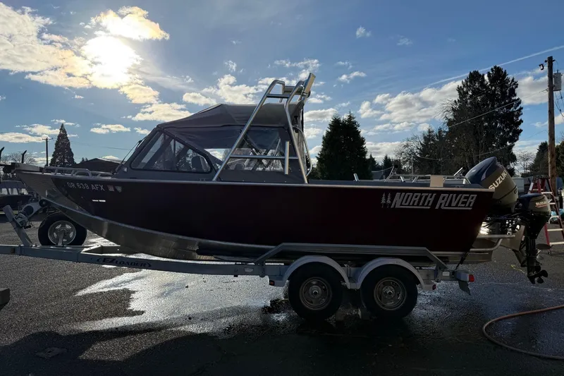 Slide: The Image of 2016 North River Seahawk boat on trailer under a bright sky. - 4