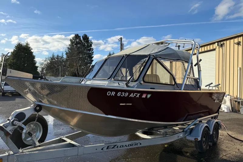 Slide: The Image of 2016 North River Seahawk boat on trailer, parked outdoors near a building. - 5