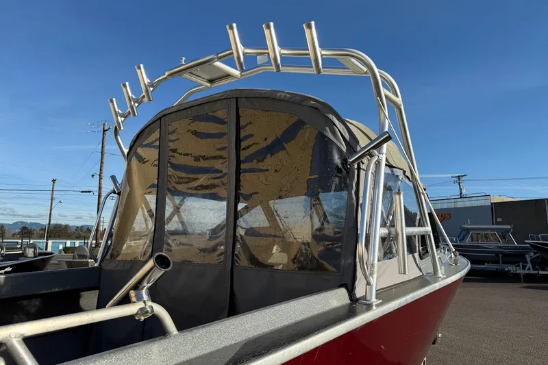 Slide: The Image of 2016 North River Seahawk boat with canopy and rod holders, parked outdoors. - 8