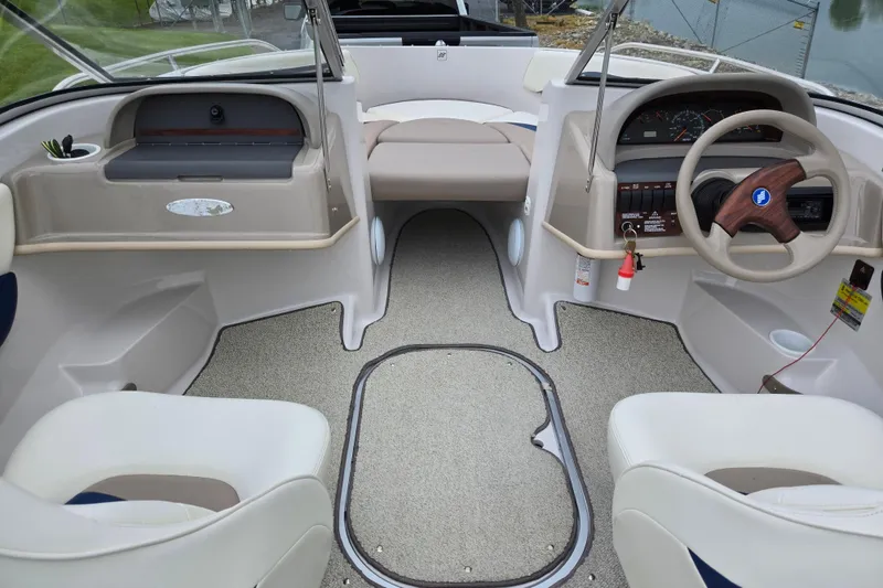Slide: The Image of 1998 Four Winns 180 Horizon boat interior with steering wheel and seating. - 11