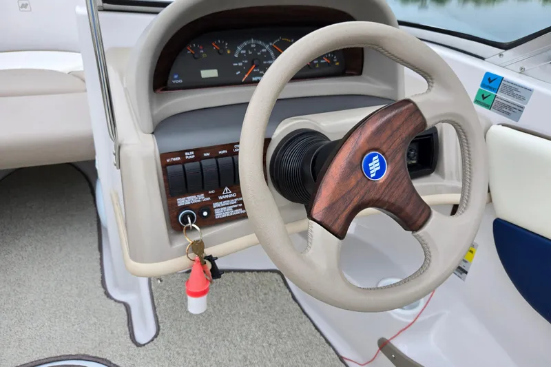 Slide: The Image of 1998 Four Winns 180 Horizon boat dashboard with steering wheel and instrument panel. - 12