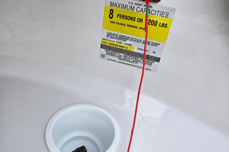 Slide: The Image of 1998 Four Winns 180 Horizon capacity label, 8 persons or 1200 lbs, with red cord. - 13